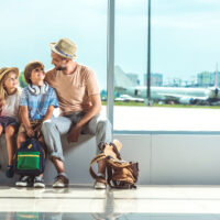 father and kids waiting for boarding